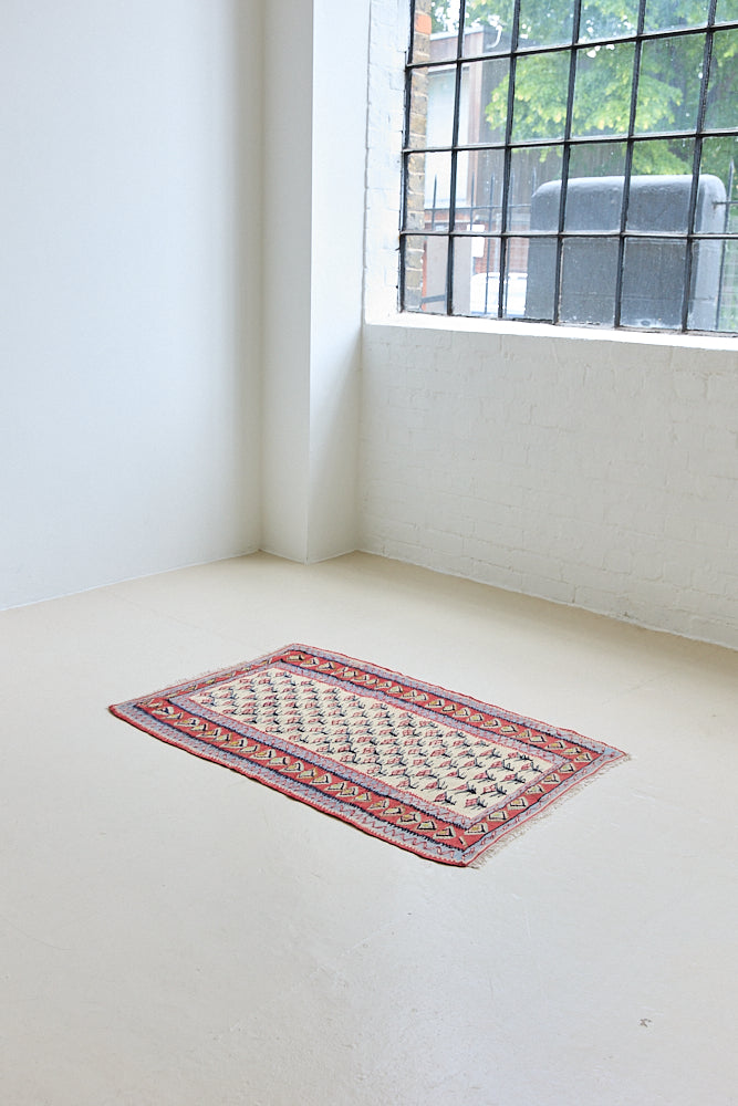 Delara is a pretty, geometric Anatolian kilim rug. Hand-woven on village and nomadic looms in vivid, naturally dyed colours, a tradition stretching back thousands of years. Kilims were woven for the practicalities of daily life and used as floor and wall coverings, storage bags, and prayer mats. Delara features a bright red floral motif across a taupe field with a contrasting taupe boarder.