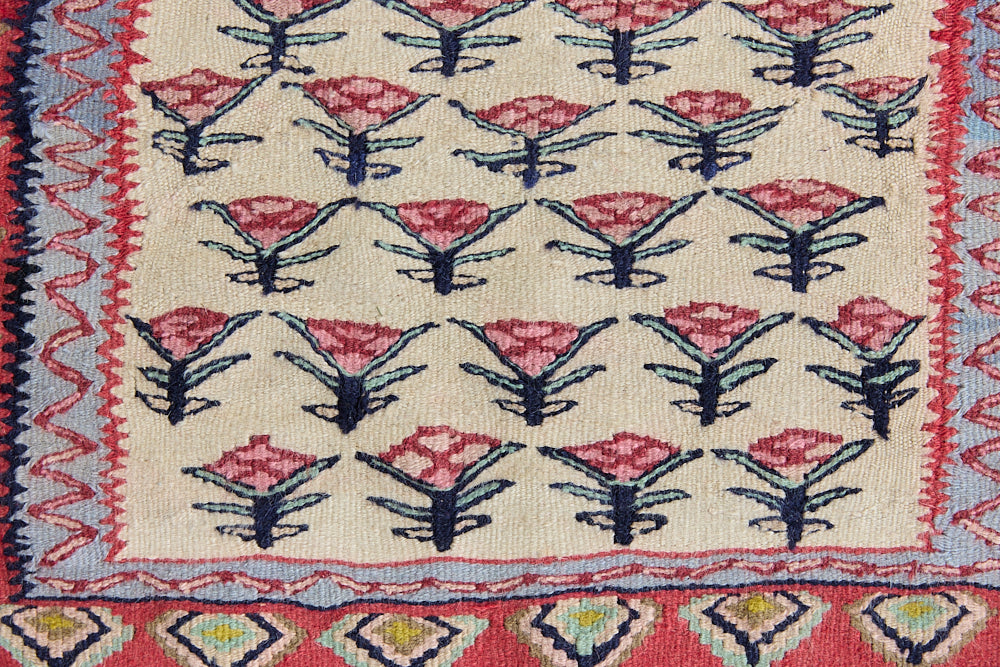 Delara is a pretty, geometric Anatolian kilim rug. Hand-woven on village and nomadic looms in vivid, naturally dyed colours, a tradition stretching back thousands of years. Kilims were woven for the practicalities of daily life and used as floor and wall coverings, storage bags, and prayer mats. Delara features a bright red floral motif across a taupe field with a contrasting taupe boarder.
