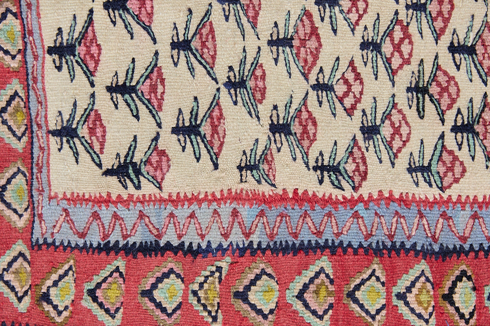 Delara is a pretty, geometric Anatolian kilim rug. Hand-woven on village and nomadic looms in vivid, naturally dyed colours, a tradition stretching back thousands of years. Kilims were woven for the practicalities of daily life and used as floor and wall coverings, storage bags, and prayer mats. Delara features a bright red floral motif across a taupe field with a contrasting taupe boarder.