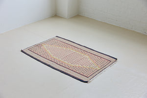 An antique Senneh kilim rug. Lale features a delicate pink and taupe central lozenge medallion on a taupe floral field with contrasting boarder.