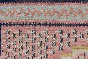 An antique Senneh kilim rug. Lale features a delicate pink and taupe central lozenge medallion on a taupe floral field with contrasting boarder.