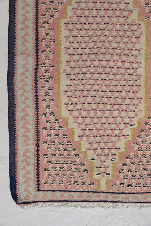 An antique Senneh kilim rug. Lale features a delicate pink and taupe central lozenge medallion on a taupe floral field with contrasting boarder.
