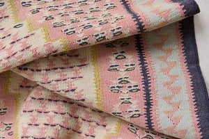 An antique Senneh kilim rug. Lale features a delicate pink and taupe central lozenge medallion on a taupe floral field with contrasting boarder.