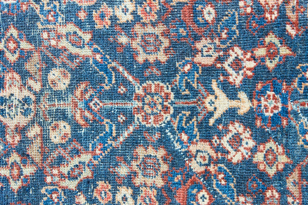 Farahan rugs are known for their high quality and are some of the most valuable Persian styles known for their repeating all over designs. Adeline is a large rug featuring a beautiful, intricate all over design on a dark blue ground with red boarder.