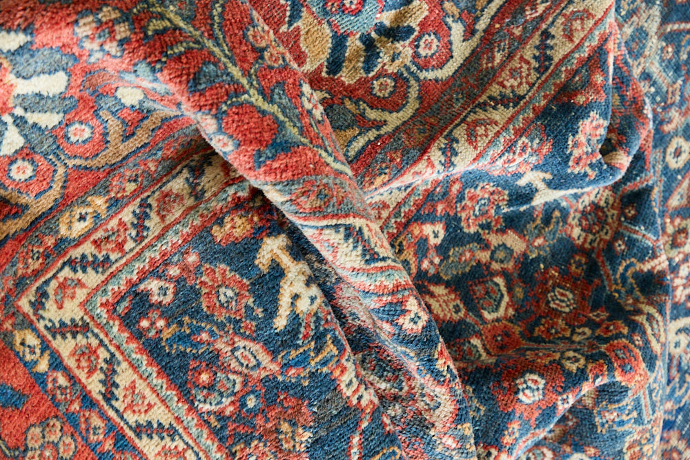 Farahan rugs are known for their high quality and are some of the most valuable Persian styles known for their repeating all over designs. Adeline is a large rug featuring a beautiful, intricate all over design on a dark blue ground with red boarder.