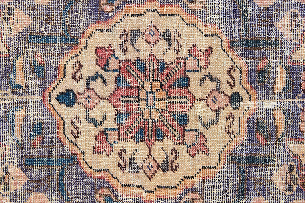 Camille is an antique hand-woven Ushak rug with two central medallions floating on a muted field of rust and taupe, anchored by a striking black floral border.