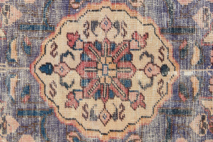 Camille is an antique hand-woven Ushak rug with two central medallions floating on a muted field of rust and taupe, anchored by a striking black floral border.