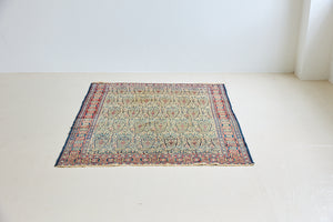 Claudette is a beautiful antique Senneh rug with an intricate design. Senneh rugs are known for their fine and intricate patterns and distinctive weaving technique. Claudette has an intricate botteh pattern and a pleasing colour palette of yellow, muted red and blue.