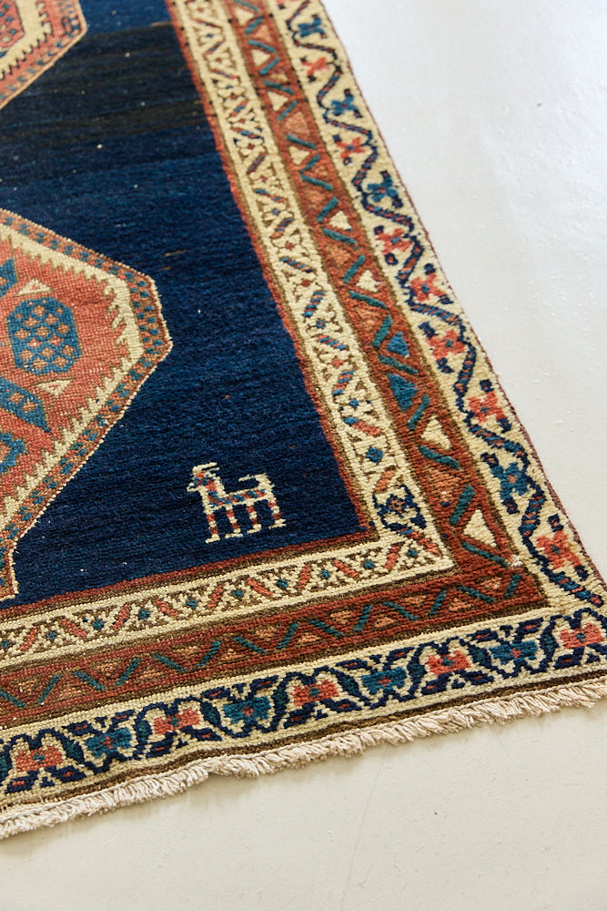 Seraphine is a beautiful antique Oushak runner with a peachy pink repeating pattern on a dark blue ground. Oushak rugs are among the most celebrated of all Turkish weavings, prized for their soft, luminous palettes and characteristically open, large-scale designs