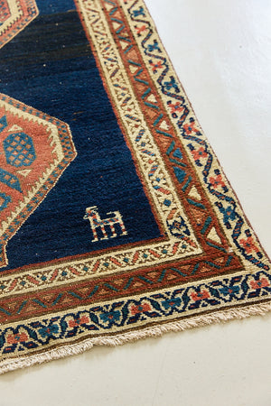 Seraphine is a beautiful antique Oushak runner with a peachy pink repeating pattern on a dark blue ground. Oushak rugs are among the most celebrated of all Turkish weavings, prized for their soft, luminous palettes and characteristically open, large-scale designs
