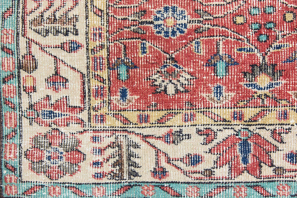 Glenda is a vintage wool rug handwoven in Turkey approximately 80 years ago. The warm terracotta field and is decorated with an all floral scrolls pattern framed by a contrasting taupe boarder.