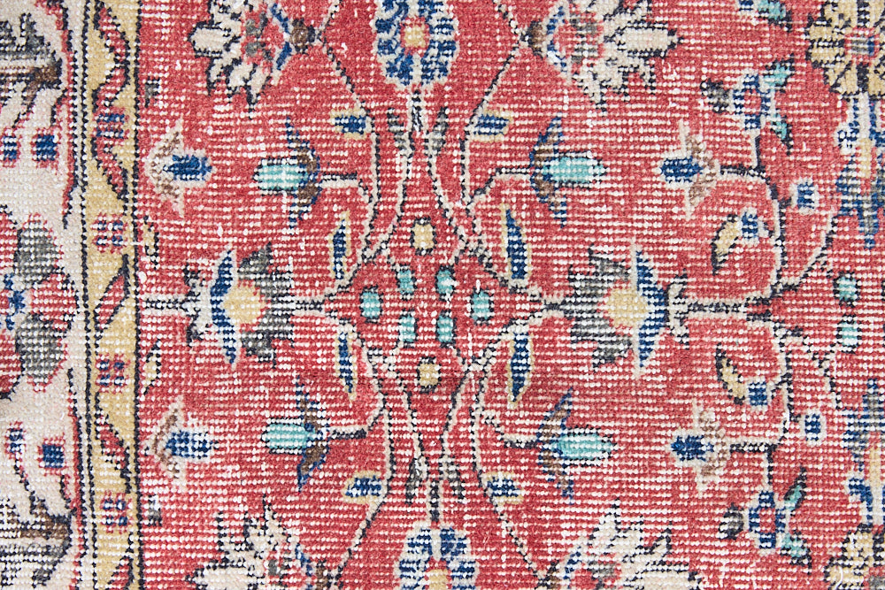 Glenda is a vintage wool rug handwoven in Turkey approximately 80 years ago. The warm terracotta field and is decorated with an all floral scrolls pattern framed by a contrasting taupe boarder.