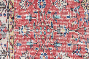Glenda is a vintage wool rug handwoven in Turkey approximately 80 years ago. The warm terracotta field and is decorated with an all floral scrolls pattern framed by a contrasting taupe boarder.