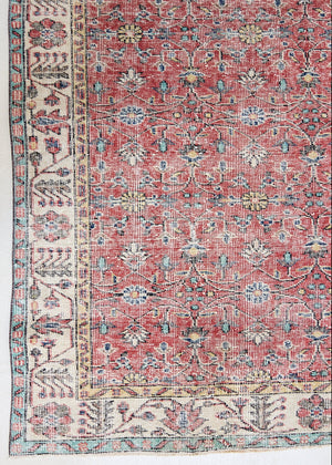 Glenda is a vintage wool rug handwoven in Turkey approximately 80 years ago. The warm terracotta field and is decorated with an all floral scrolls pattern framed by a contrasting taupe boarder.
