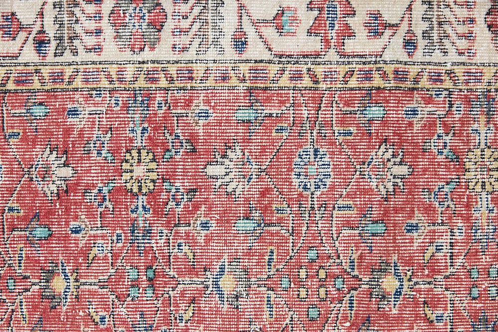 Glenda is a vintage wool rug handwoven in Turkey approximately 80 years ago. The warm terracotta field and is decorated with an all floral scrolls pattern framed by a contrasting taupe boarder.