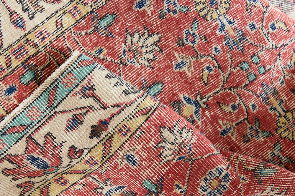 Glenda is a vintage wool rug handwoven in Turkey approximately 80 years ago. The warm terracotta field and is decorated with an all floral scrolls pattern framed by a contrasting taupe boarder.