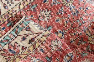 Glenda is a vintage wool rug handwoven in Turkey approximately 80 years ago. The warm terracotta field and is decorated with an all floral scrolls pattern framed by a contrasting taupe boarder.