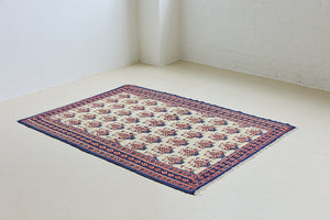 Isolde is a vintage geometric Anatolian kilim rug. Hand-woven on village and nomadic looms in vivid, naturally dyed colours, a tradition stretching back thousands of years. Kilims were woven for the practicalities of daily life and used as floor and wall coverings, storage bags, and prayer mats. Isolde features a pretty pink floral motif across a taupe field with a contrasting dark blue boarder.