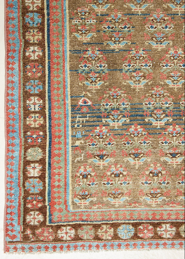 Decorative antique Persian runner with intricate patterns and colours. 