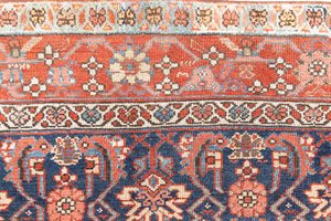 This is a Persian Mahal carpet which are known for decorative designs and repeating floral patterns. This Vintage hand woven rug features a midnight navy ground complimented by a rich red border.