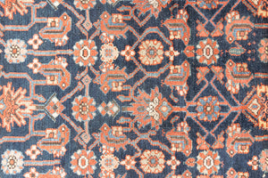 This is a Persian Mahal carpet which are known for decorative designs and repeating floral patterns. This Vintage hand woven rug features a midnight navy ground complimented by a rich red border.