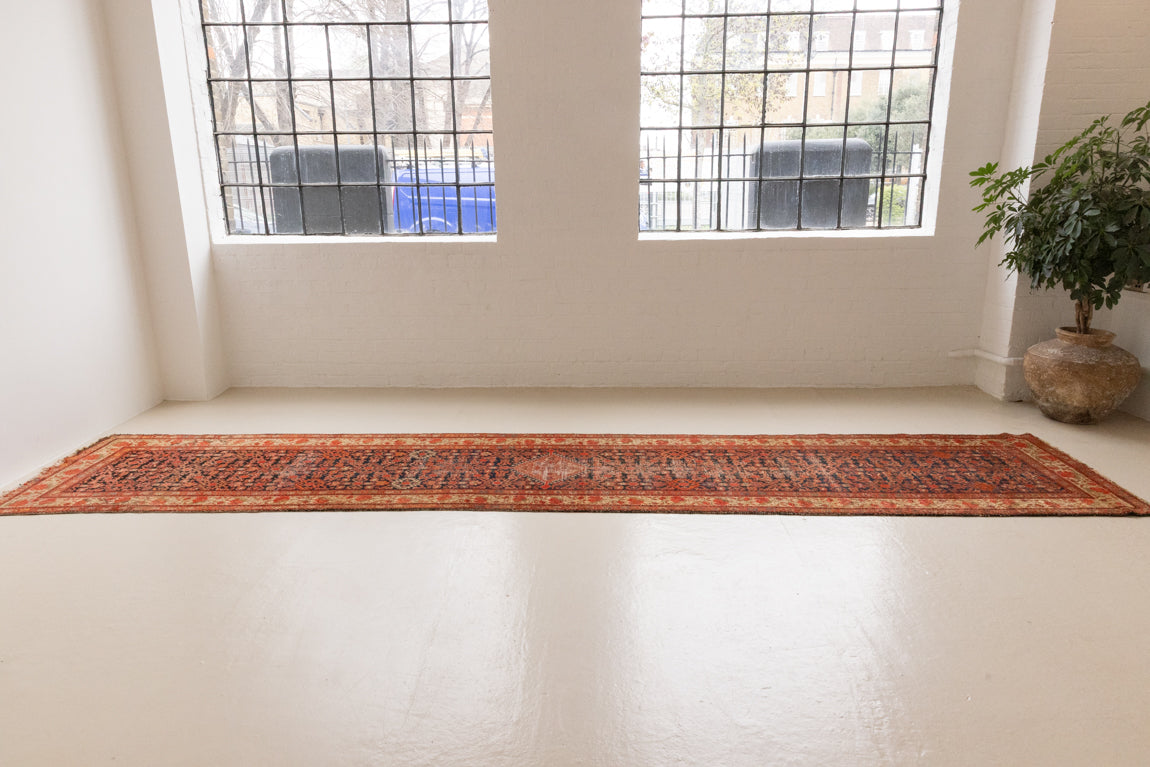The Malayer region is known for producing some of the most ornate Persian carpets, often known for their mesmerising and intricate repeating patterns.This extra long handwoven vintage runner rug features a beautiful intricate design and lots of character and charm.