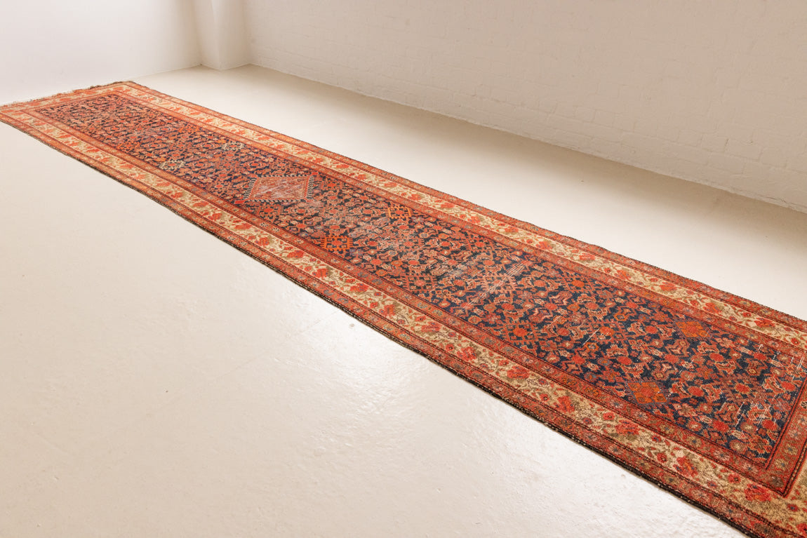 The Malayer region is known for producing some of the most ornate Persian carpets, often known for their mesmerising and intricate repeating patterns.This extra long handwoven vintage runner rug features a beautiful intricate design and lots of character and charm.