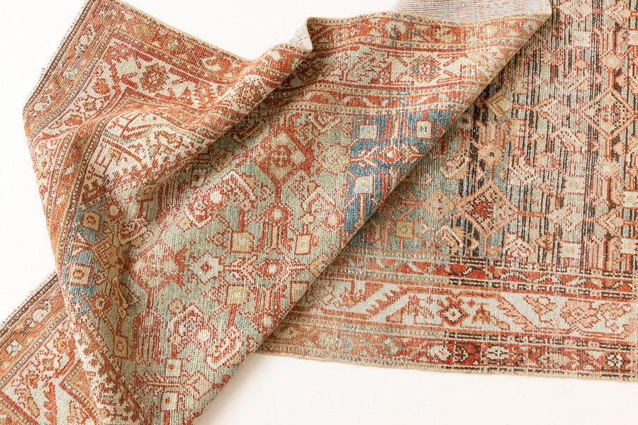 This is a Persian Malayer runner rug with a beautiful palette of blues and terracotta and a wonderful patina. Persia produces this finest carpets and this is one of them.