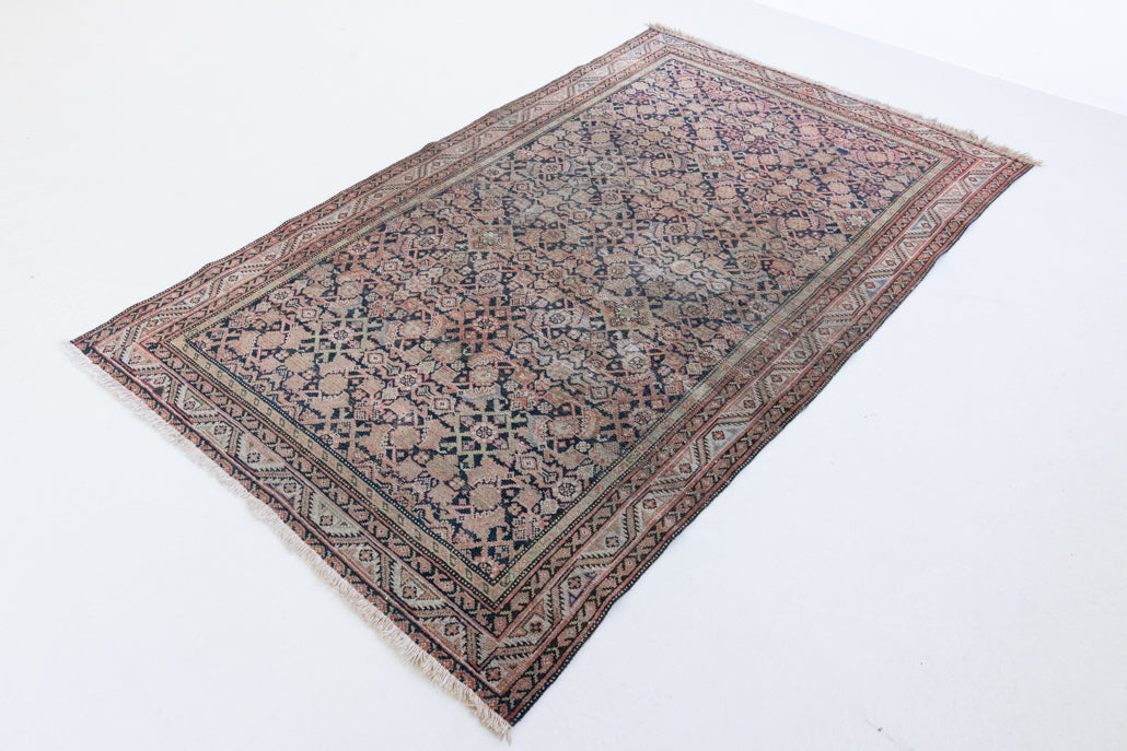 Eden is a muted pink antique Persian Malayer rug, handwoven in the North West of Iran. The Malayer region is known for ornate Persian carpets. 