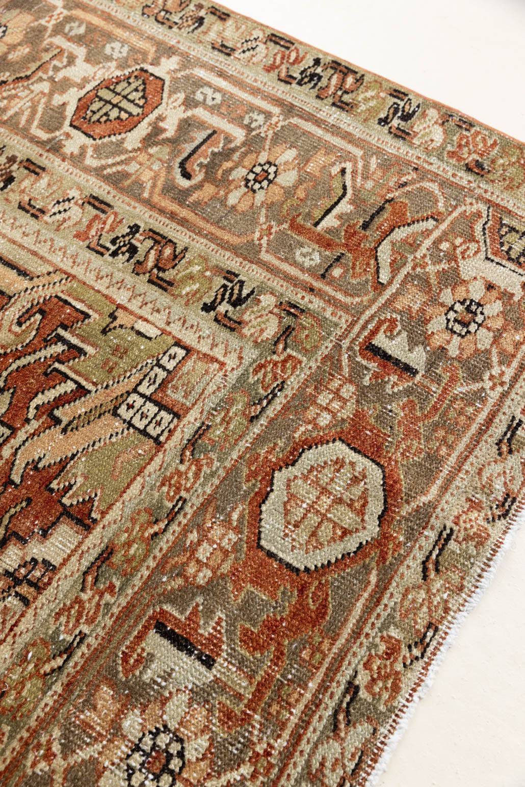 This is a antique Persian Heriz rug that has been over-dyed to gently fade its original colours, giving a more neutral palette. Persia has the most desirable rugs and carpets with stunning designs such as this carpet. Now available at Ourika London.