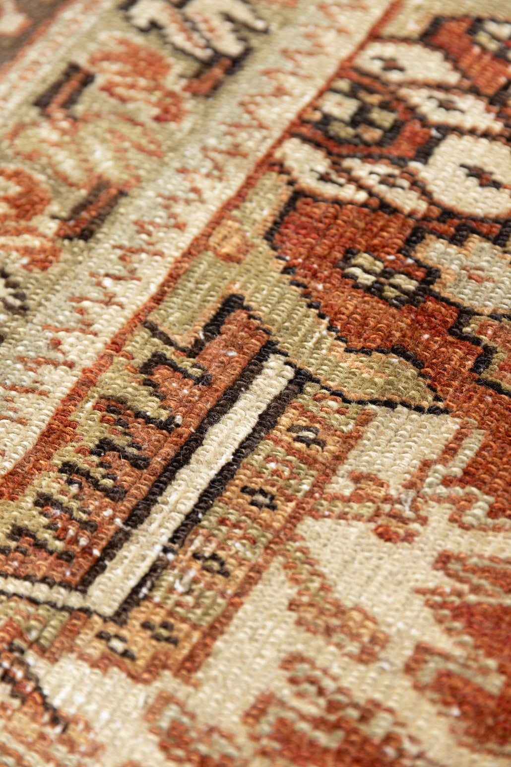 This is a antique Persian Heriz rug that has been over-dyed to gently fade its original colours, giving a more neutral palette. Persia has the most desirable rugs and carpets with stunning designs such as this carpet. Now available at Ourika London.