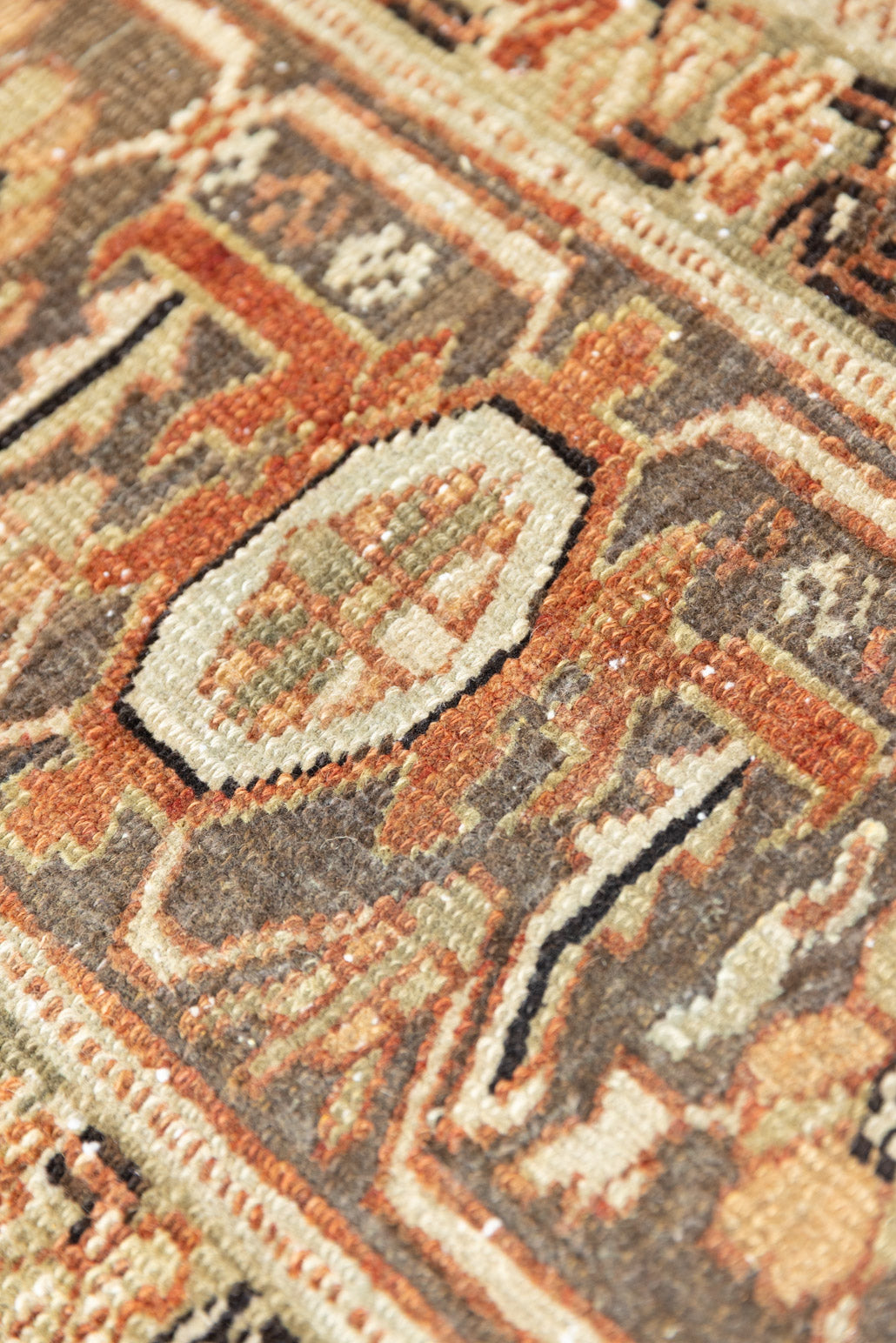 This is a antique Persian Heriz rug that has been over-dyed to gently fade its original colours, giving a more neutral palette. Persia has the most desirable rugs and carpets with stunning designs such as this carpet. Now available at Ourika London.