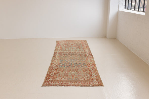 This is a Persian Malayer runner rug with a beautiful palette of blues and terracotta and a wonderful patina. Persia produces this finest carpets and this is one of them.