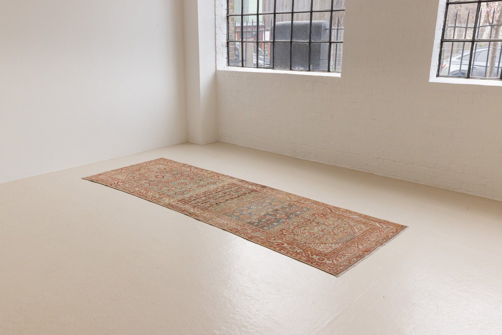 This is a Persian Malayer runner rug with a beautiful palette of blues and terracotta and a wonderful patina. Persia produces this finest carpets and this is one of them.