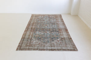 This is a antique Persian Malayer rug that has been over-dyed to gently fade its original colours, giving a more neutral palette. Persia has the most desirable rugs and carpets with stunning designs such as this carpet. Now available at Ourika London.