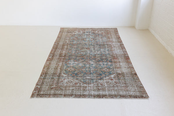 This is a antique Persian Malayer rug that has been over-dyed to gently fade its original colours, giving a more neutral palette. Persia has the most desirable rugs and carpets with stunning designs such as this carpet. Now available at Ourika London.