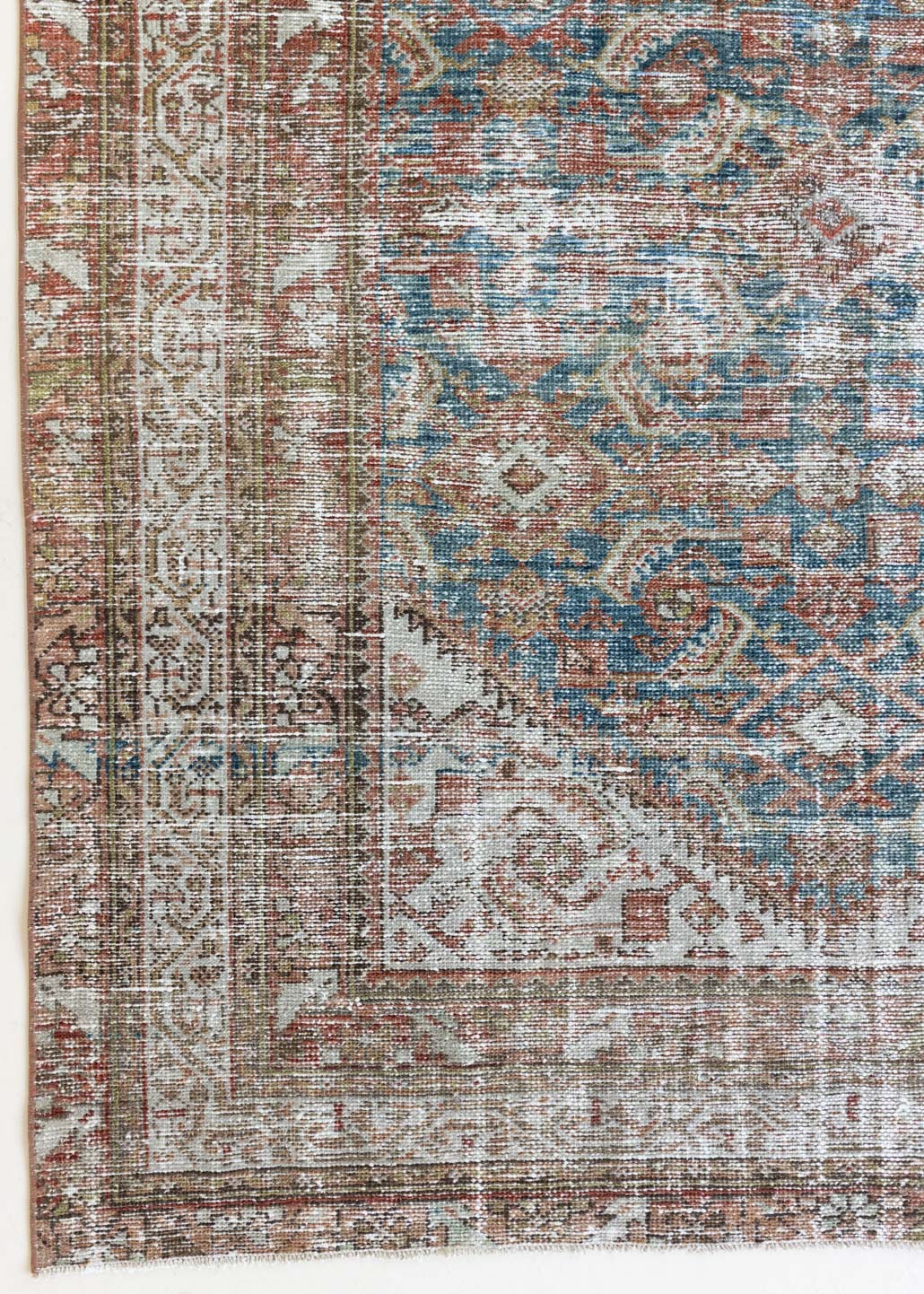 This is a antique Persian Malayer rug that has been over-dyed to gently fade its original colours, giving a more neutral palette. Persia has the most desirable rugs and carpets with stunning designs such as this carpet. Now available at Ourika London.