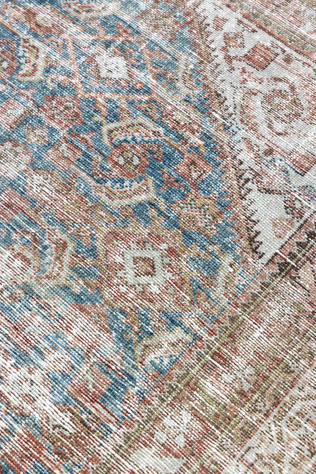 This is a antique Persian Malayer rug that has been over-dyed to gently fade its original colours, giving a more neutral palette. Persia has the most desirable rugs and carpets with stunning designs such as this carpet. Now available at Ourika London.
