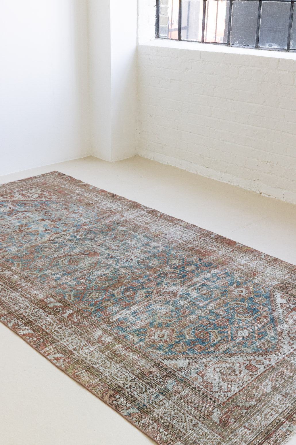This is a antique Persian Malayer rug that has been over-dyed to gently fade its original colours, giving a more neutral palette. Persia has the most desirable rugs and carpets with stunning designs such as this carpet. Now available at Ourika London.
