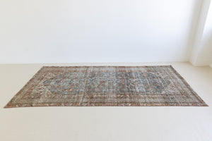 This is a antique Persian Malayer rug that has been over-dyed to gently fade its original colours, giving a more neutral palette. Persia has the most desirable rugs and carpets with stunning designs such as this carpet. Now available at Ourika London.