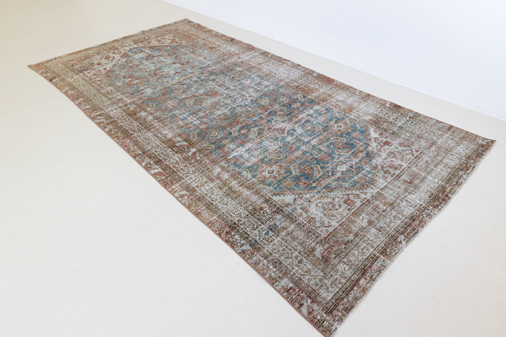 This is a antique Persian Malayer rug that has been over-dyed to gently fade its original colours, giving a more neutral palette. Persia has the most desirable rugs and carpets with stunning designs such as this carpet. Now available at Ourika London.
