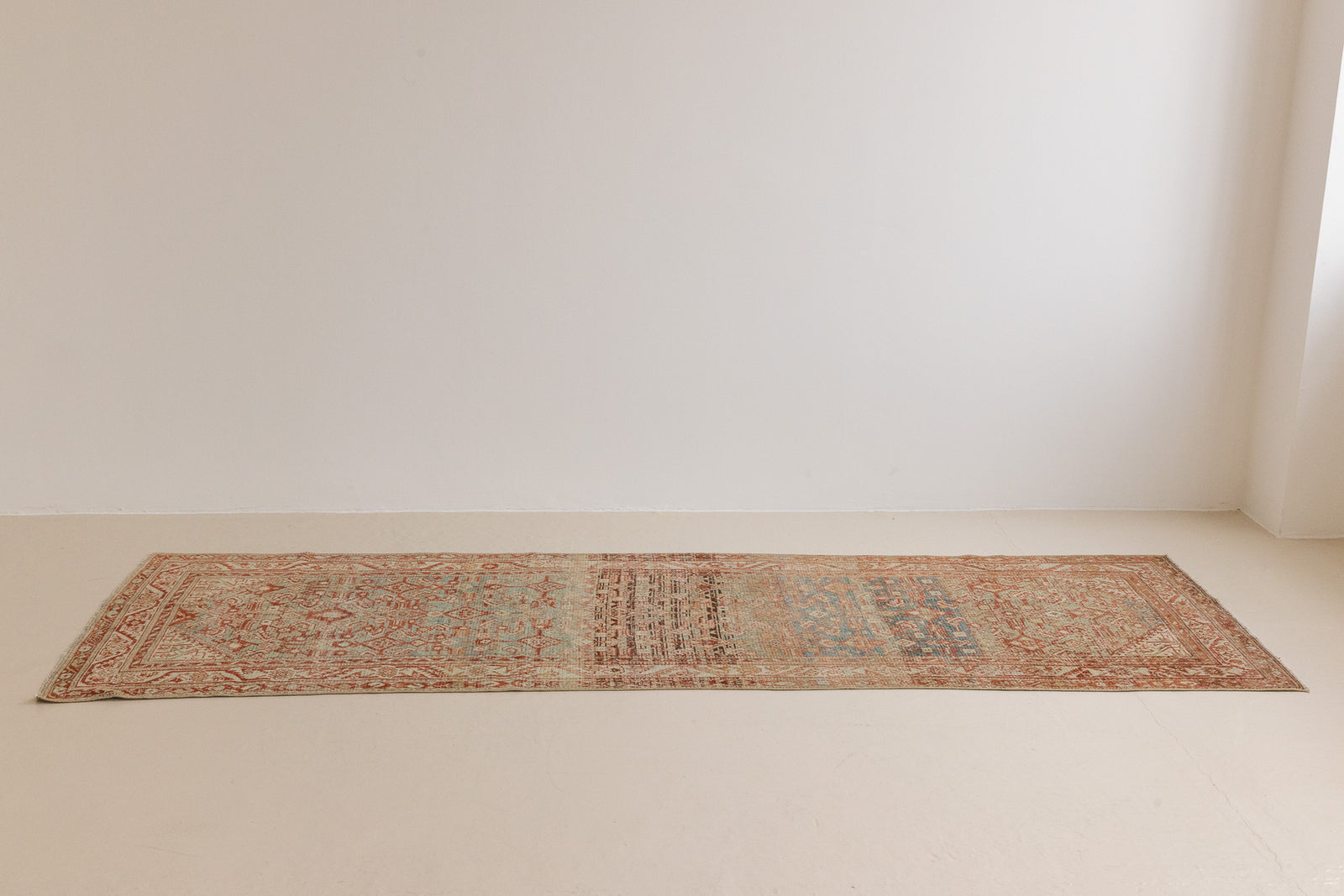 This is a Persian Malayer runner rug with a beautiful palette of blues and terracotta and a wonderful patina. Persia produces this finest carpets and this is one of them.