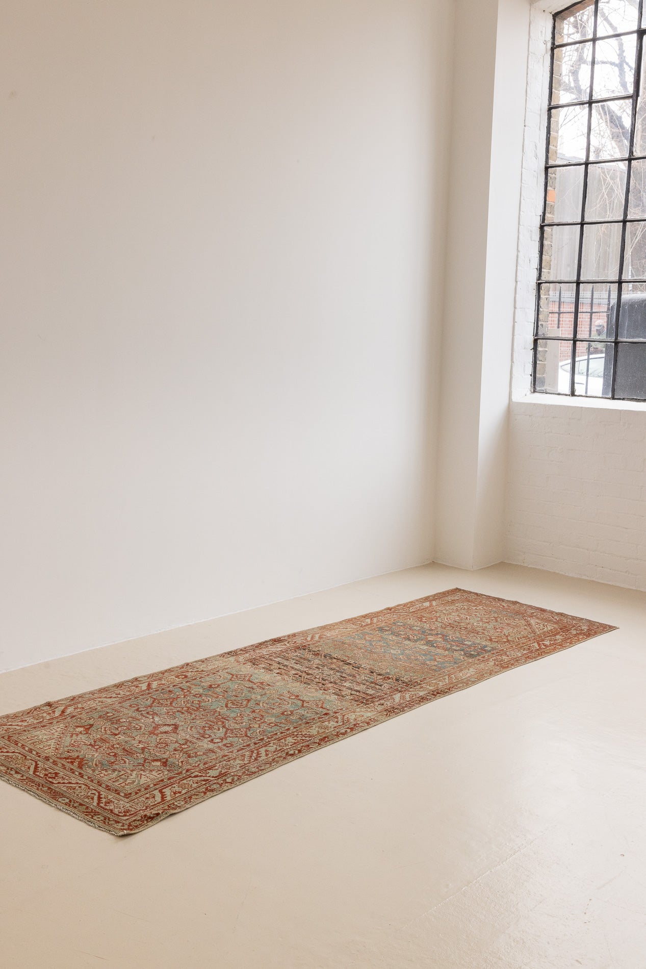 This is a Persian Malayer runner rug with a beautiful palette of blues and terracotta and a wonderful patina. Persia produces this finest carpets and this is one of them.