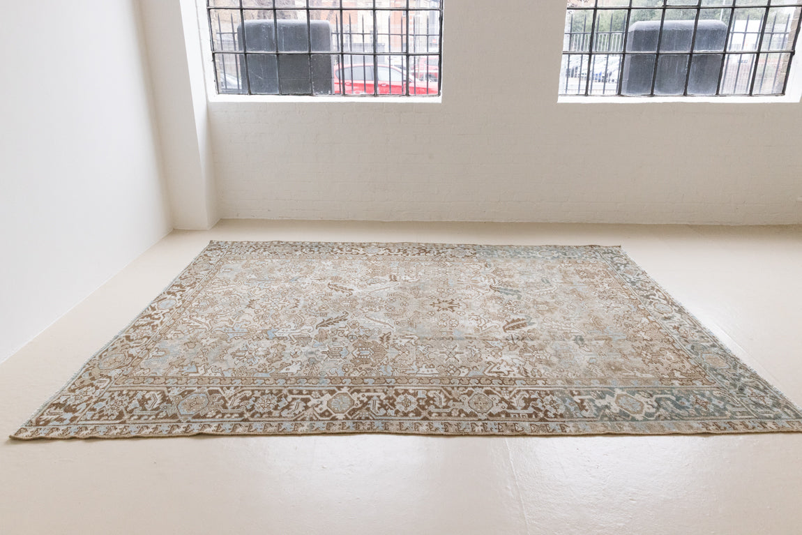 This is a beautiful muted Persian Heriz carpet from Persia. This hand woven rug features a lovely blue grey and brown colour palet.