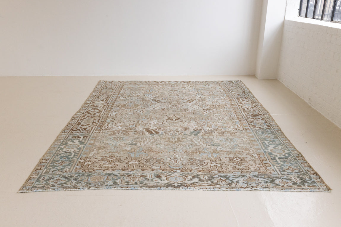 This is a beautiful muted Persian Heriz carpet from Persia. This hand woven rug features a lovely blue grey and brown colour palet.
