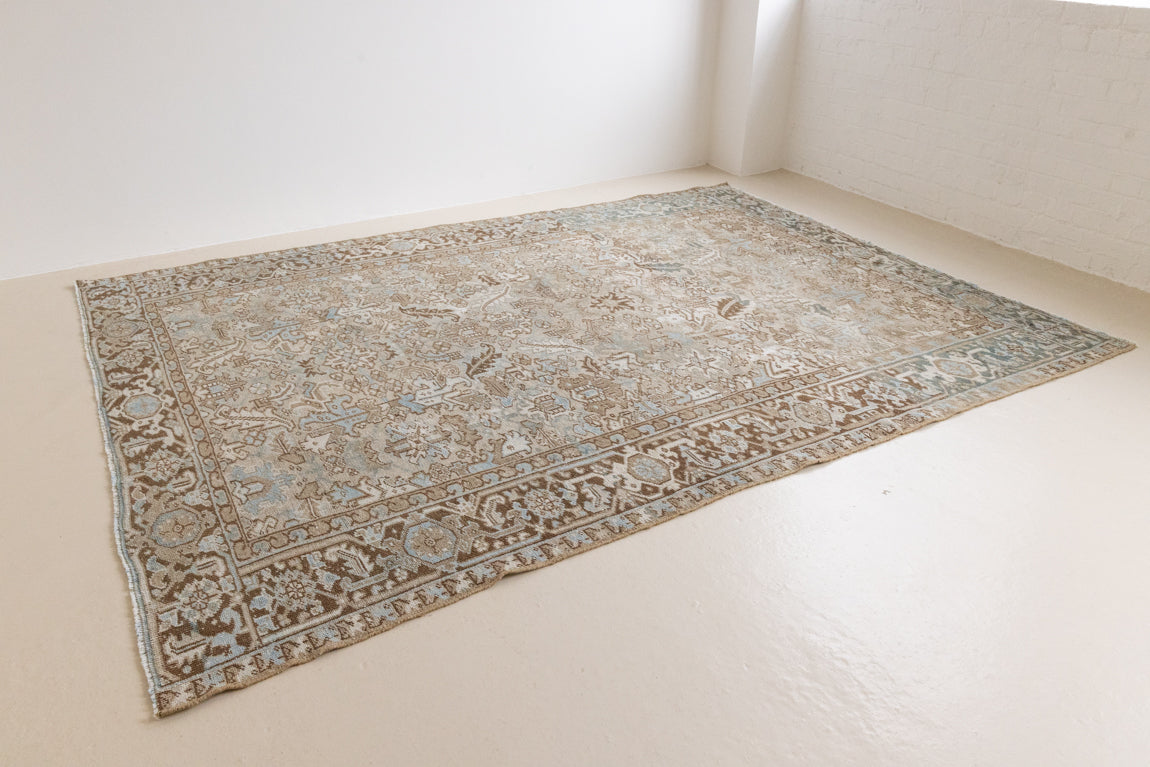 This is a beautiful muted Persian Heriz carpet from Persia. This hand woven rug features a lovely blue grey and brown colour palet.