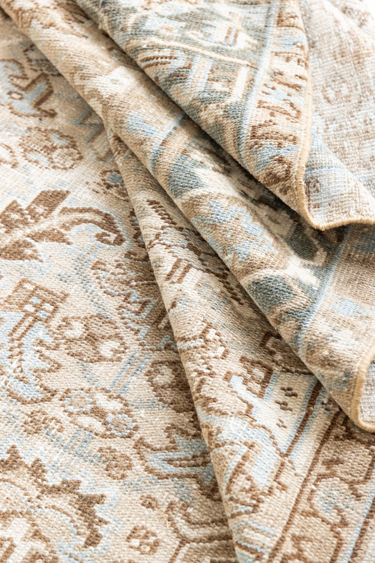 This is a beautiful muted Persian Heriz carpet from Persia. This hand woven rug features a lovely blue grey and brown colour palet.