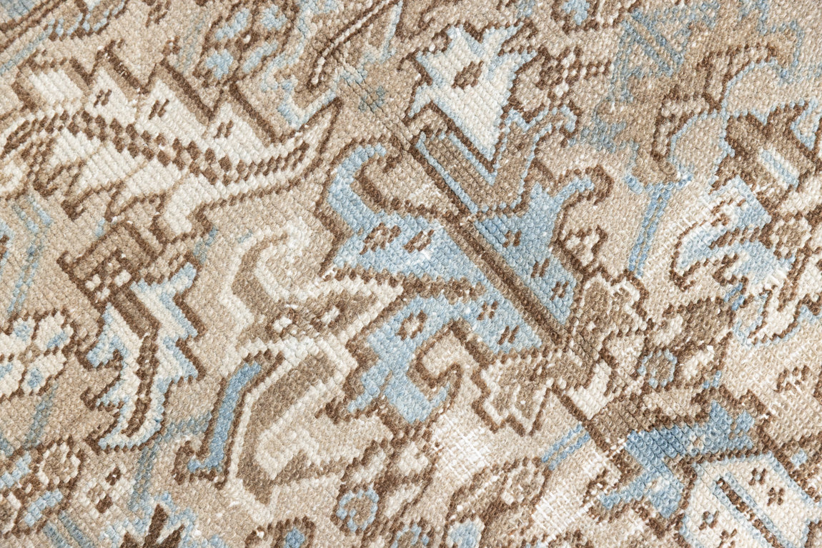 This is a beautiful muted Persian Heriz carpet from Persia. This hand woven rug features a lovely blue grey and brown colour palet.