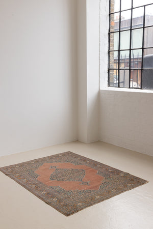 Selma is a beautiful antique Persian Tabriz rug with a soft yet bold coral colour palette and a stunning abrash and patina with a lovely central medallion within the carpet.