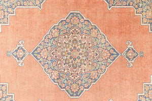 Selma is a beautiful antique Persian Tabriz rug with a soft yet bold coral colour palette and a stunning abrash and patina with a lovely central medallion within the carpet.